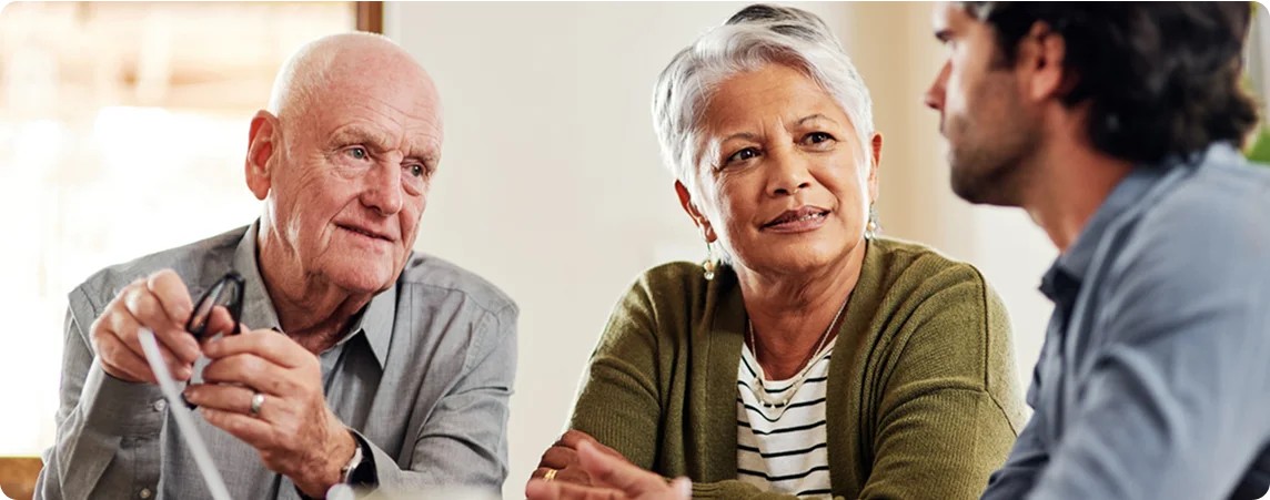 Elderly couple reviewing care options together