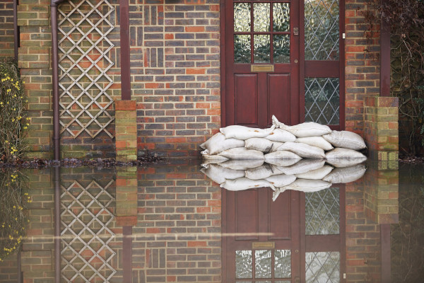 Sandbags in front of a door preventing flood coming in