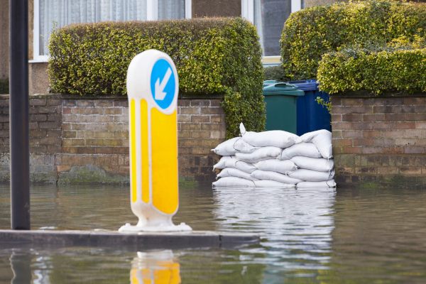 Sandbags placed on a house's entryway to protect the property from a flood.